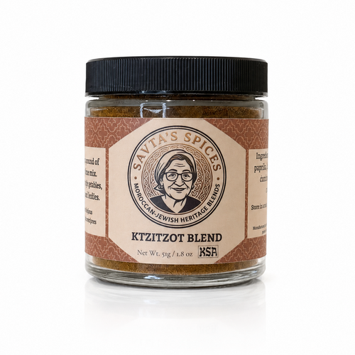 A jar of Savta's Spices Ktzitzot Blend spice mix, featuring a clear glass jar filled with brown spice blend, a black screw cap, and a beige and brown label with the brand logo.