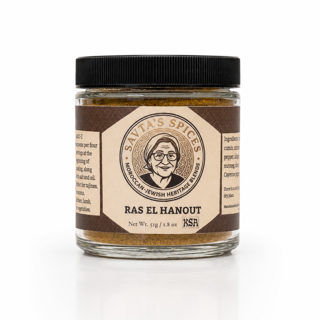 A glass jar of Ras El Hanout spice blend by Savias Spices, featuring a black lid and a brown and beige label with a portrait illustration, set against a clean white background.