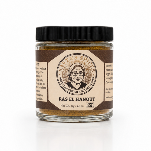 A glass jar of Ras El Hanout spice blend by Savias Spices, featuring a black lid and a brown and beige label with a portrait illustration, set against a clean white background.